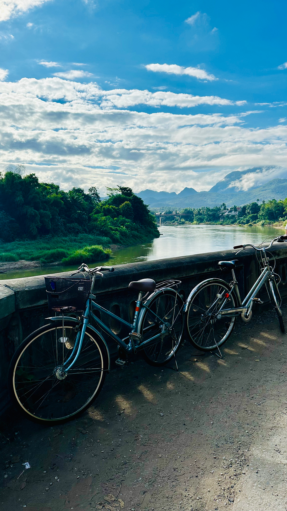 Minimalist landscape photography capturing mist-covered mountains and calm rivers in Laos.