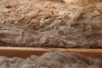 Image of old, deteriorated attic insulation demonstrating the importance of insulation removal that has debris, dust, and contamination that reduces energy efficiency and indoor air quality.