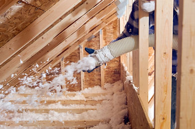 Image of a technician installing blown-in insulation — evenly distributing eco-friendly material to enhance energy efficiency, improve comfort, and fill hard-to-reach attic spaces.