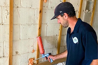 Wild Elements Solutions insulation expert performing precision air sealing in Tampa, FL — using advanced foam application to block drafts, improve energy efficiency, and protect indoor air quality.