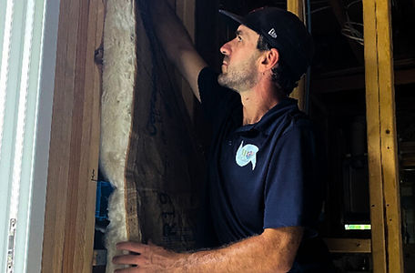 Image of a Wild Elements Solutions insulation expert installing batting insulation on a residential project in Tampa, FL, enhancing energy efficiency, comfort, and indoor air quality.