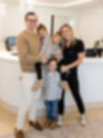 Dr. Rob Walsh, Dr. Colleen Ahern, and their three kids in the lobby of Smile Stories