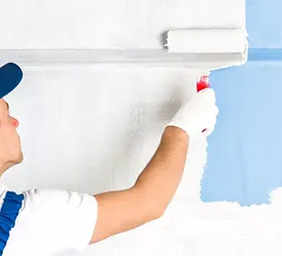professional_paints_a_blue_wall-825x450.webp