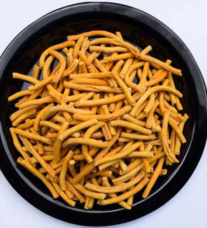 Thumbnail: Savory orange snack sticks on black plate