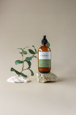 Amber pump bottle with cosmetics and personal care label on a rock