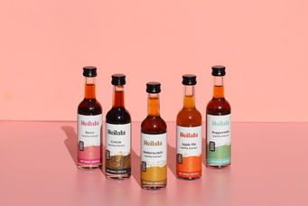 Five bottles of Bellala food labels sauces on pink 배경.