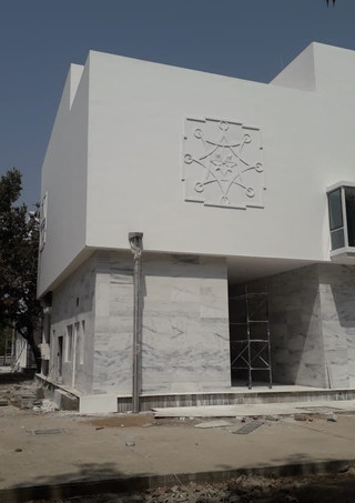 Floating museum galleries with Jain Ashtamangal motifs, jharokhas and graphic symbols on the exterior marble facade in heritage Museum