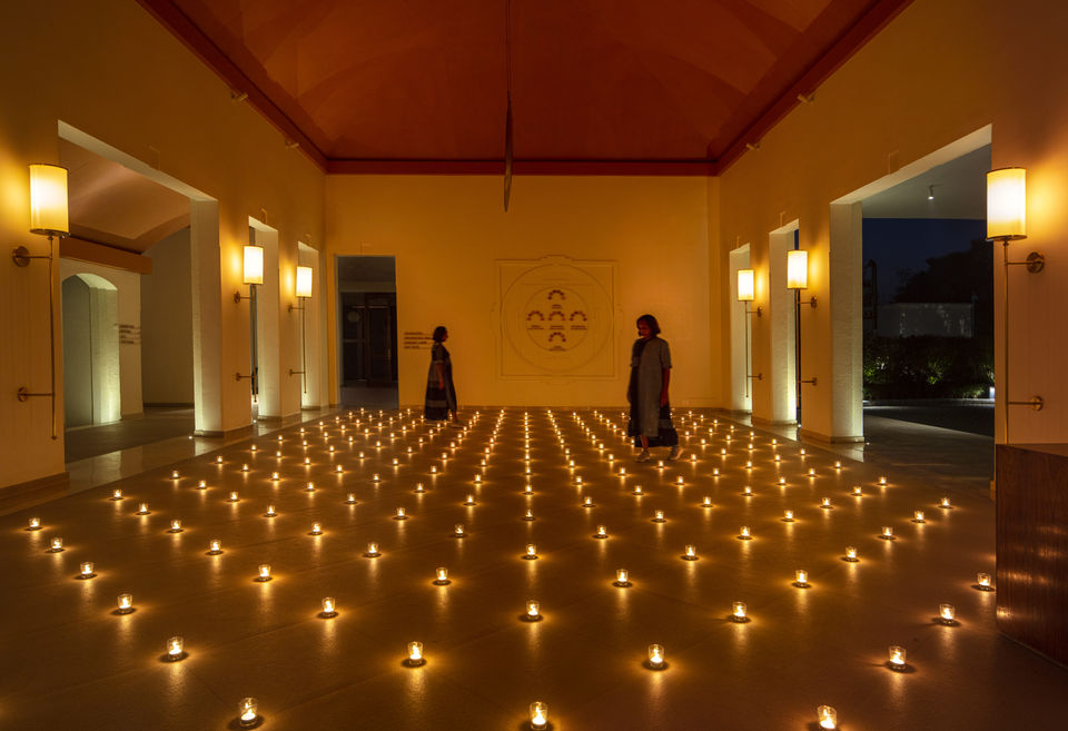 Terracotta ceiling, tile flooring in a reception area, diya lamps in a hotel, vaulted ceiling interior design, Buddhism inspired hotel interior design