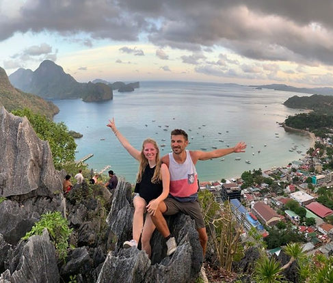 Couple enjoying panoramic views from the summit of Mount English on Manamoc Island after a scenic four-hour guided hike from Amanpulo