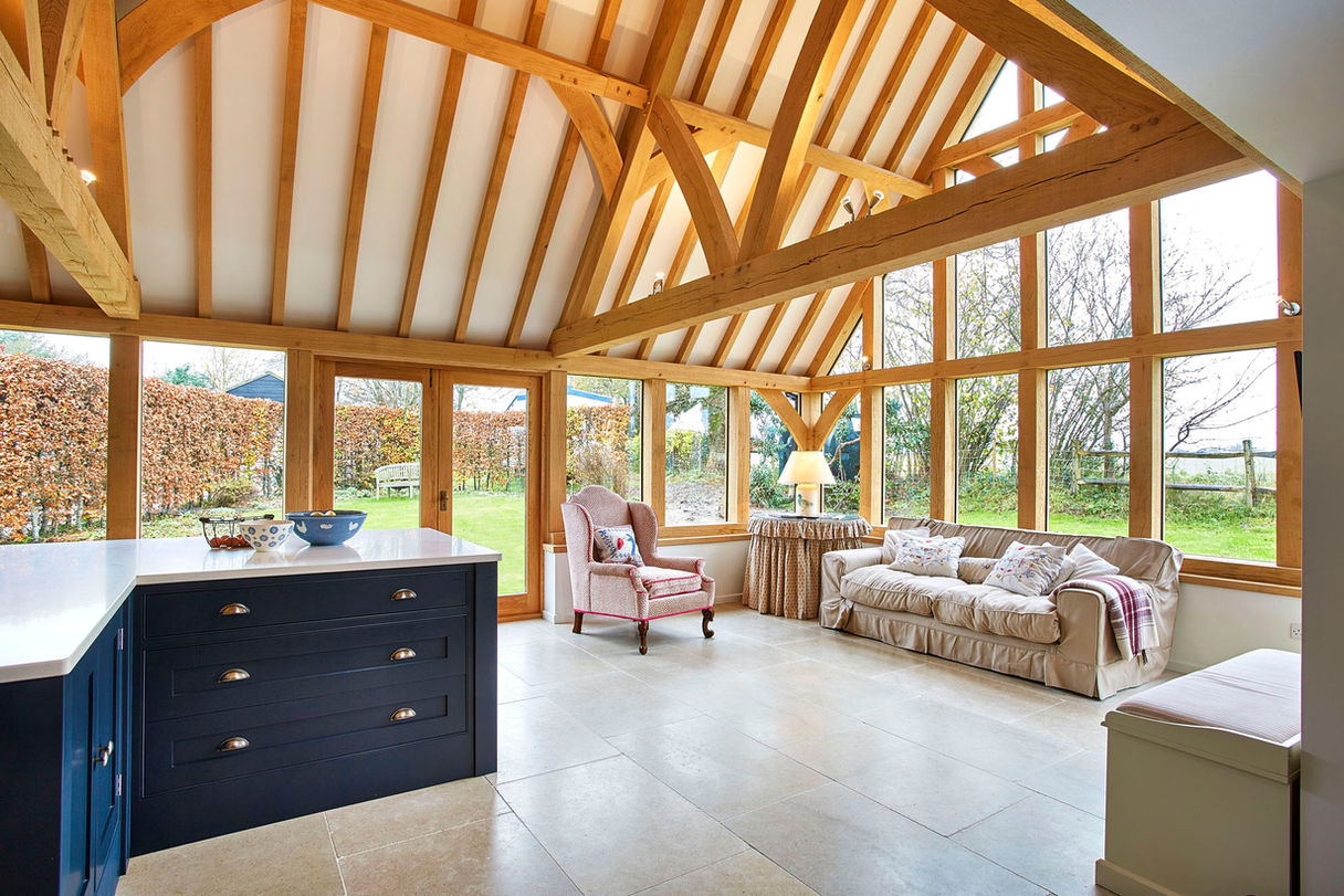 Bright living room with kitchen and dining space, part of an oak kitchen extension porch in Plastow Green by Hartwood Oak.
