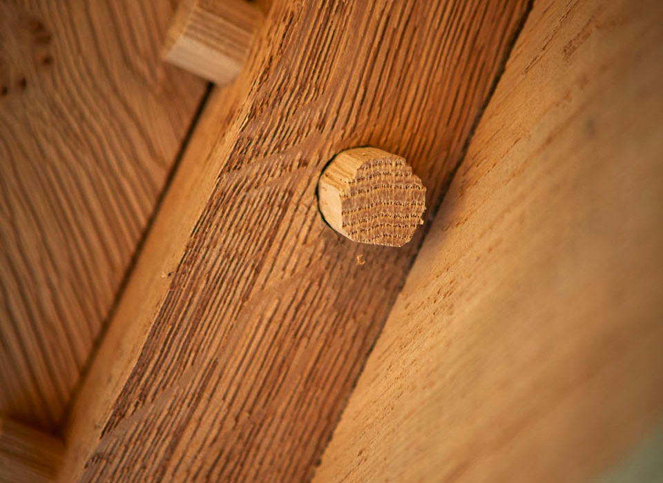 A wooden matchstick rests on a wooden table in the Oak Garden Room in Hungerford by Hartwood Oak.