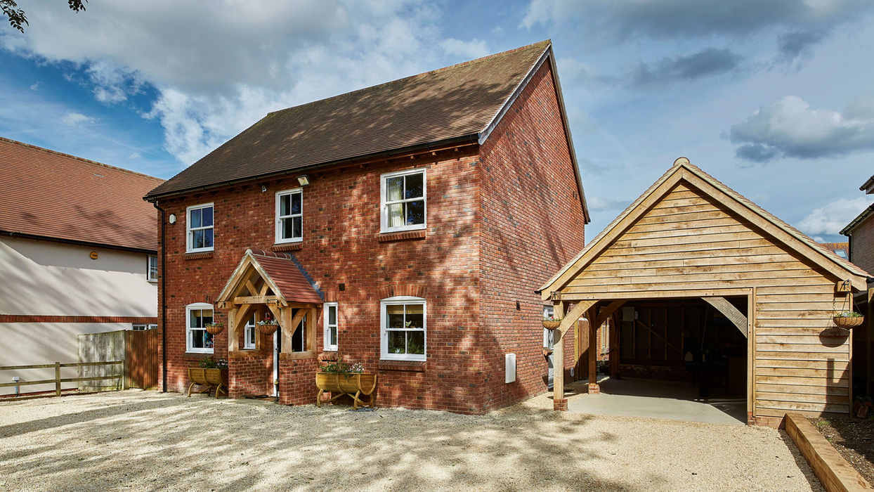 House with a driveway and garage, highlighting an oak extension porch in Chieveley by Hartwood Oak.