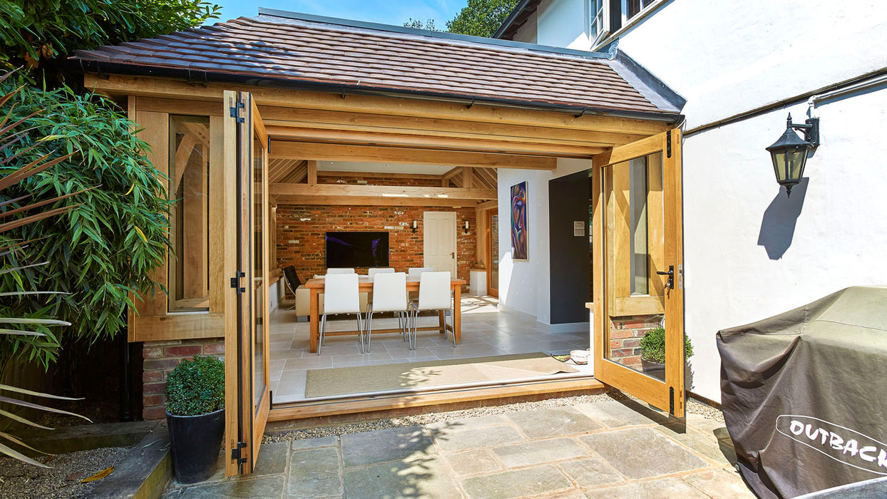 Charming patio and dining area outdoors, featuring an oak orangery by Hartwood Oak, located in Burghclere.