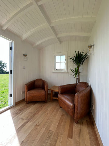 A modern oak home office with a desk and chair, designed by Hartwood Oak in Berkshire.
