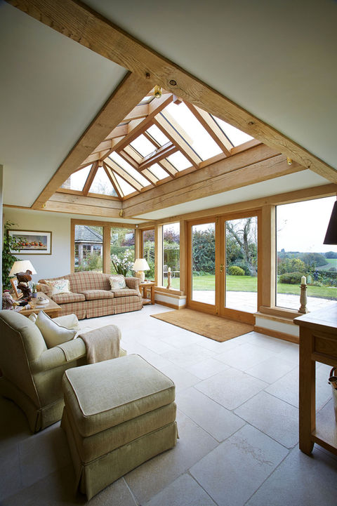 Spacious living room with a stunning glass roof, part of the Oak Orangery in Ashampstead by Hartwood Oak.