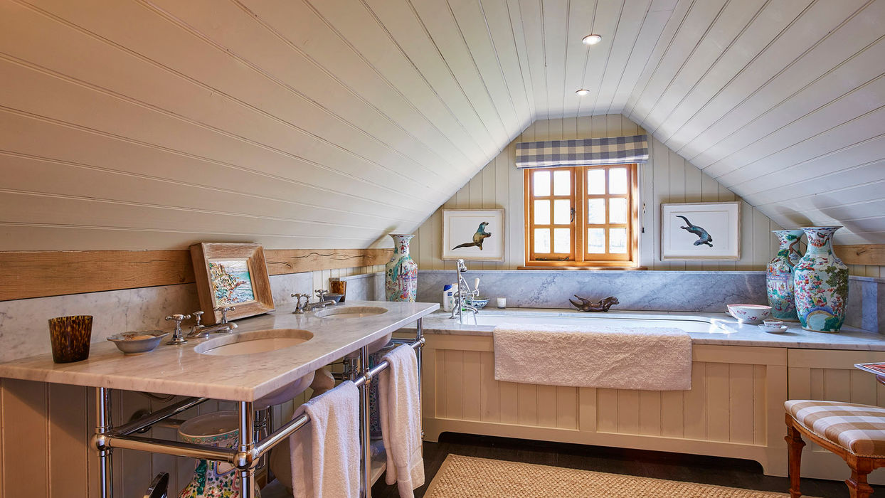 Bright bathroom with a sink, bathtub, and window, located in the oak guest lodge barn in Tadley by Hartwood Oak.