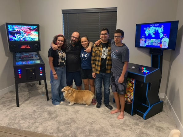 family standing in a game room