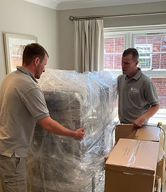 two movers packing up stuff inside a house.jpg