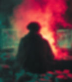 Person in hoodie at desk with two monitors showing stock charts, surrounded by cash stacks, in red smoke-filled room, intense mood.