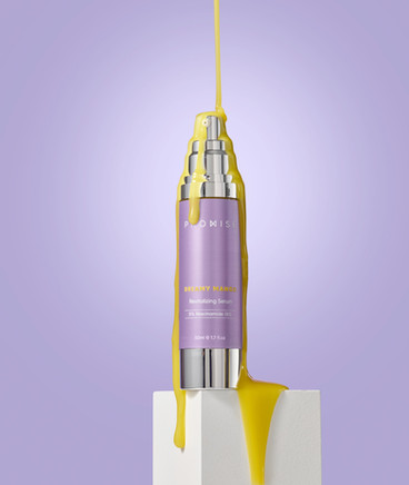 A Hero shot of a Promis's revitalizing serum with purple background. the dripping on the bottle was composed out of three different shots.