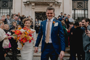 Couple surrounded by confetti after the ceremony 