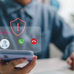 man checking his phone for scam calls