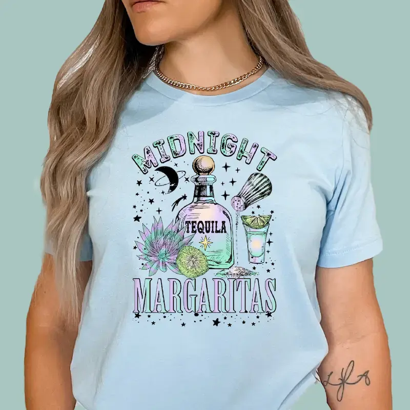Light blue t-shirt with "Midnight Margaritas" graphic featuring a tequila bottle, margarita glass, and cactus.