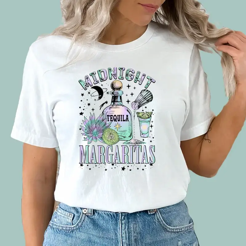 White cotton "Midnight Margaritas" tee with vibrant celestial and desert-themed design.