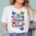 A person wearing a white "The Lord Is My Strength and My Song" graphic t-shirt featuring a vertical arrangement of colorful,