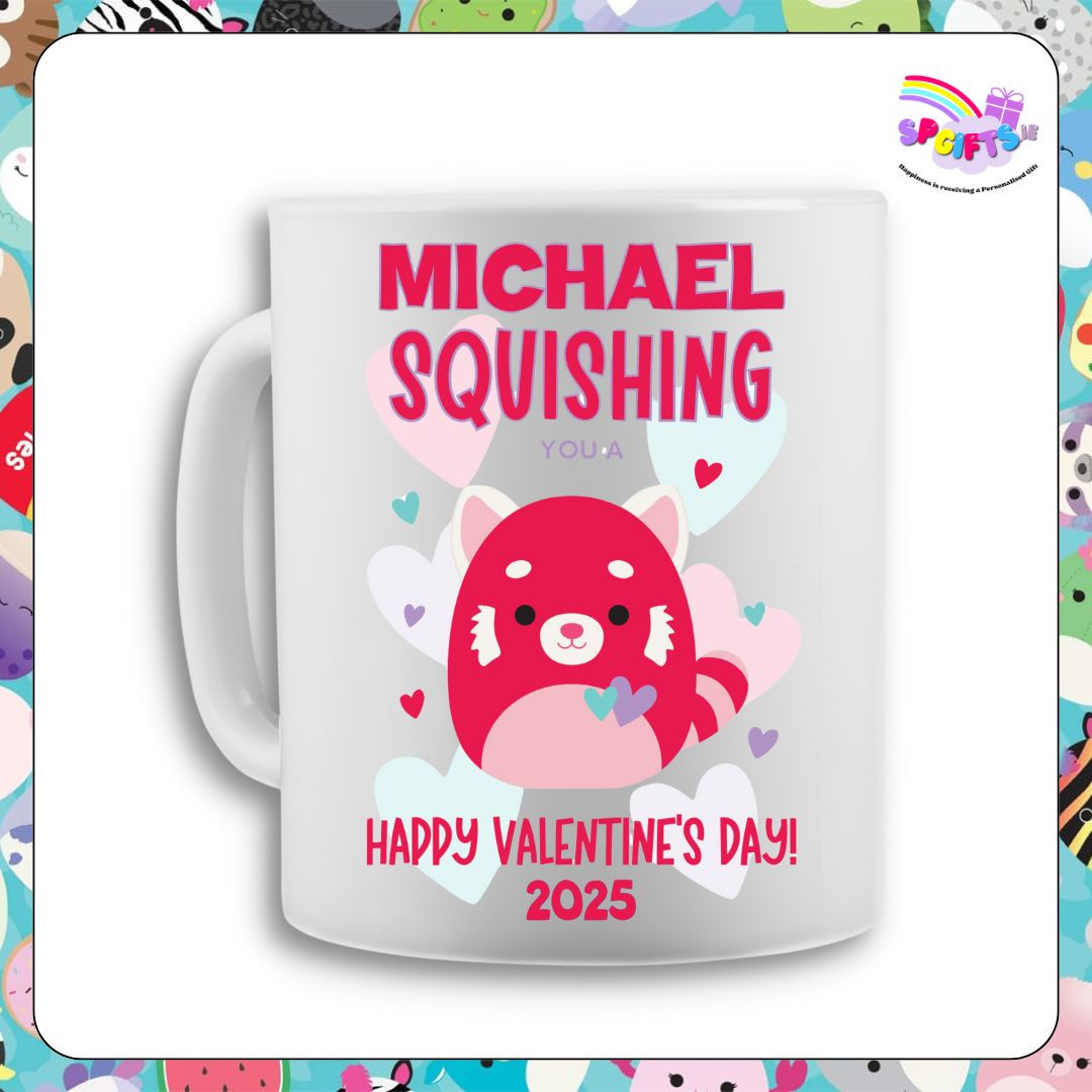 A white ceramic mug featuring a red panda Squish design with hearts