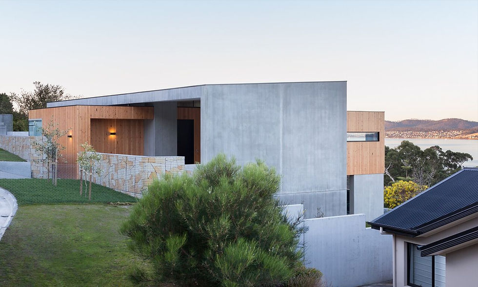 Modern concrete and wood construction home with water view