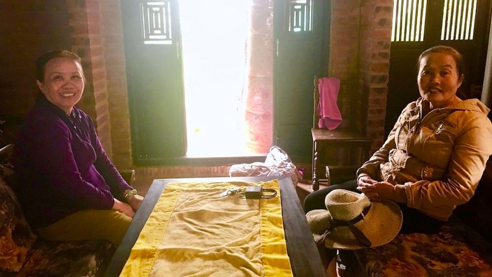 A photograph of local Vietnamese residents who invited themselves in to say hello as Hannah and Naomi moved house.