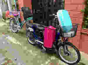 A photograph of an electric bike and pedal bike laden with shopping in Hoi An, Vietnam.