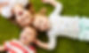 childhood, leisure and family concept - happy little kids lying on floor or carpet_edited.