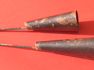 The agogô made up of two metal bells of different sizes, played with a stick to create a series of high-pitched notes.