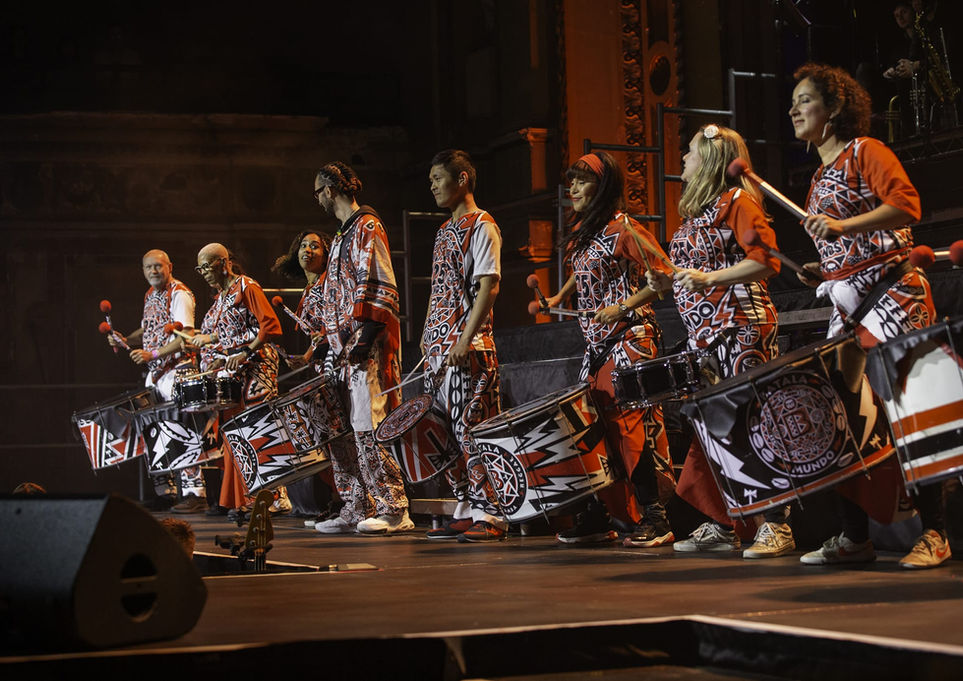 Batala London members performing on stage at Alexandra Palace