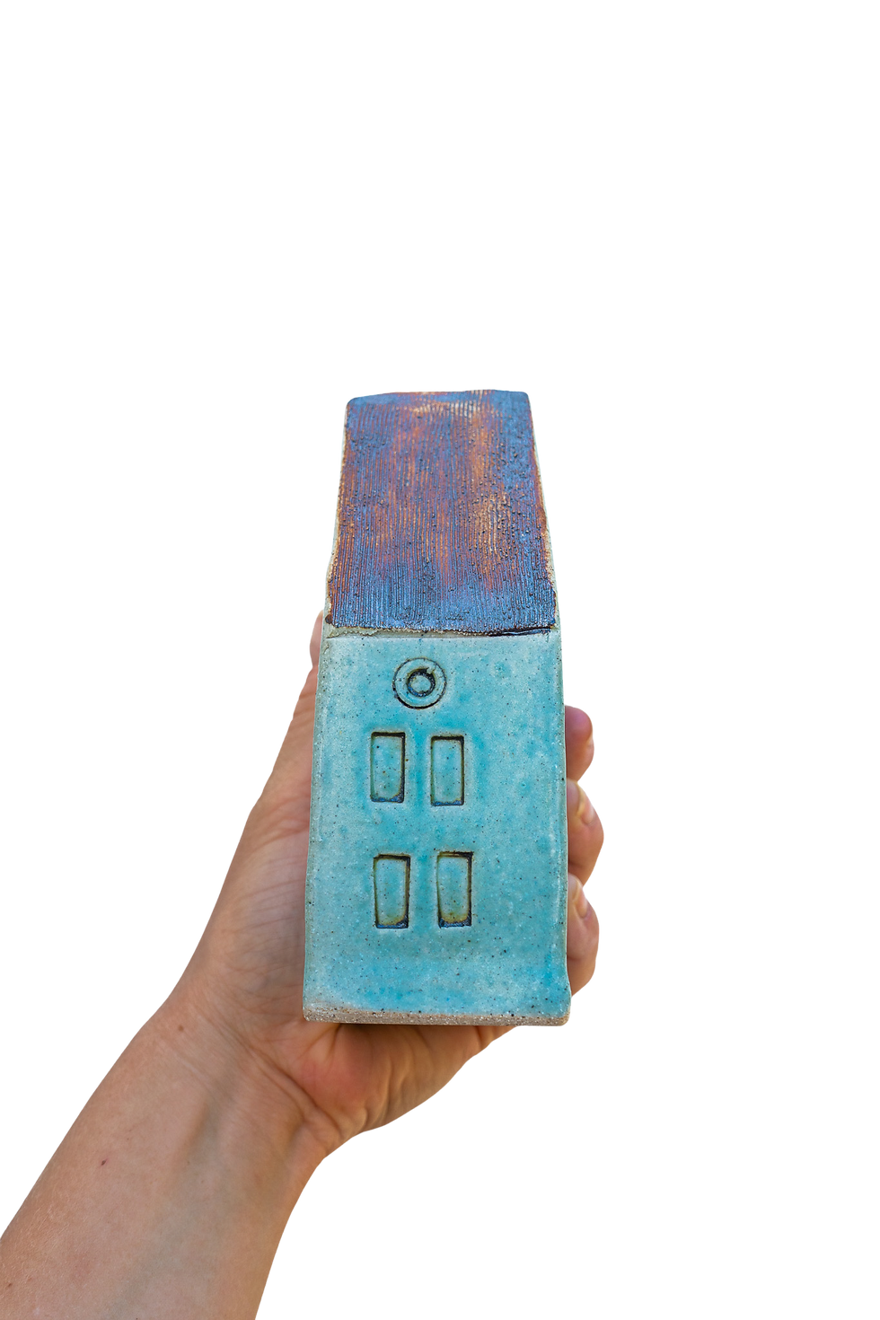 a hand holding a Double Turquoise Ceramic House sculpture on a white background, side view