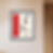 a mockup of a watercolour painting of red stripe with symbols and black strokes in a black frame on a wall
