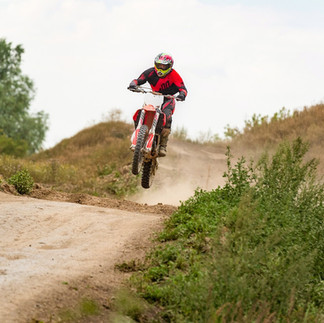 person riding on motocross in the hills