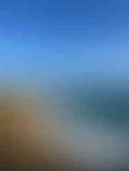 a photo of the yellow cliffs and a sea with waves with blue sky