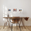 Miniatura: a mockup of 3 watercolour paintings of hanging in a bright room with wooden table and chair