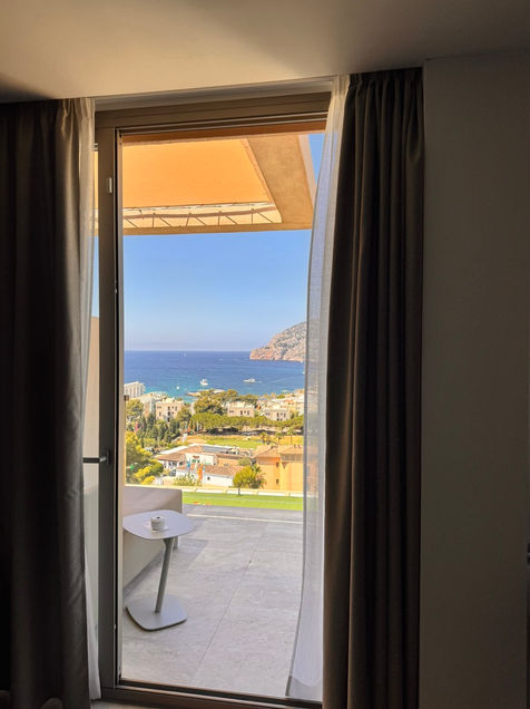 Sunny view of coastal town and blue sea from a room