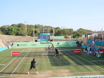 Tennis players competing on an outdoor court in Mallorca