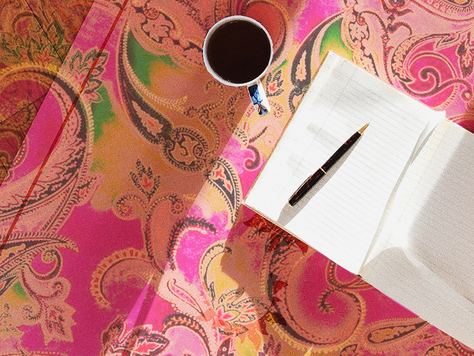 Person writing brand voice notes in a notebook for social media content outsourcing strategy.
