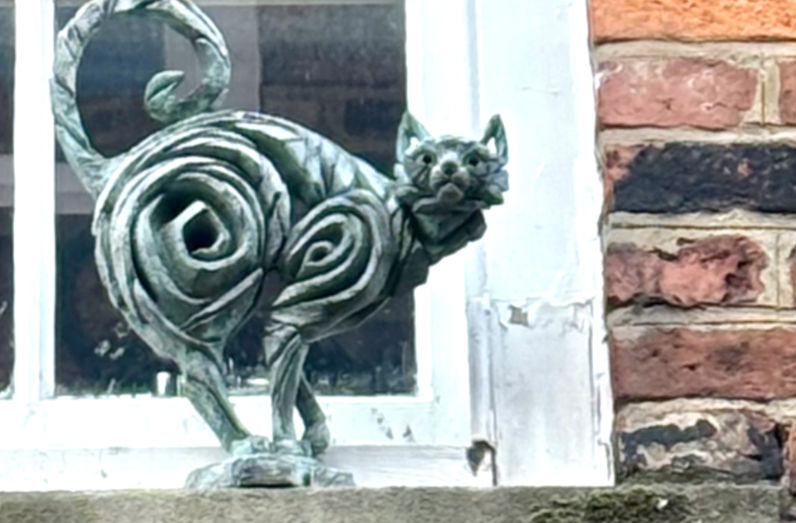 Cat sculpture on a windowsill