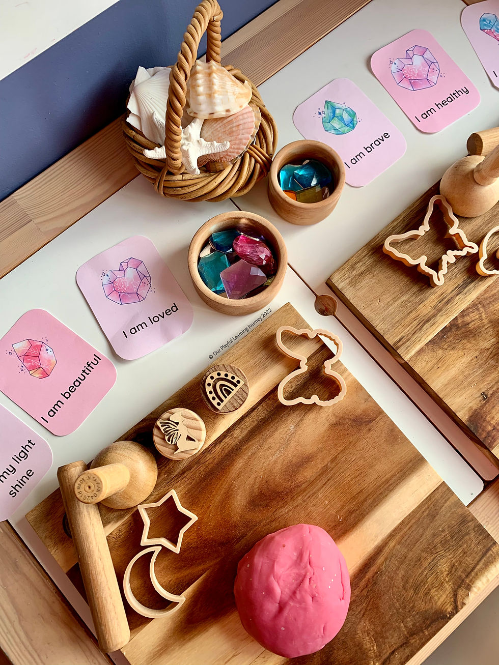 Free printable affirmation cards for kids set up with a playdough invitation to play, with crystals and shells.