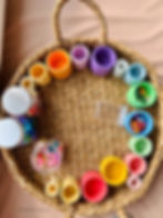 Grapat coloured nest bowls with gems and jewels in a basket for loose parts play for kids