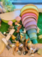 Farm small world play using open ended toys including a Grimms rainbow