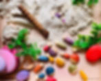 sensory play tray for kids with sand and Grapat bugs.