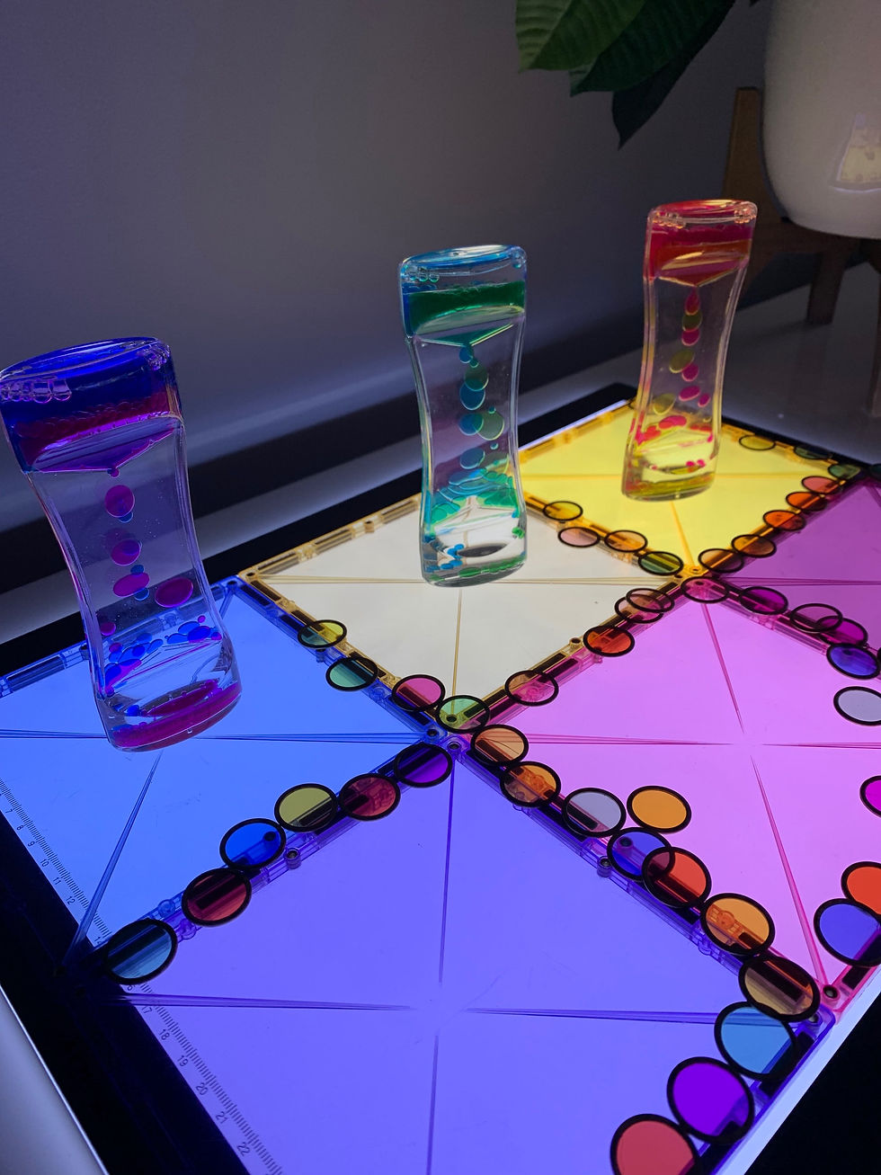 Light panel play ideas for kids exploring magnetic chips and magnetic tiles.